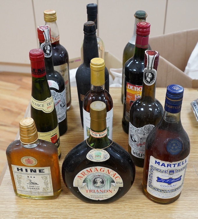 Twelve various bottles of alcohol including a bottle of Trianon 1974 Armagnac, a bottle of Martell three star cognac etc. Condition - storage unknown